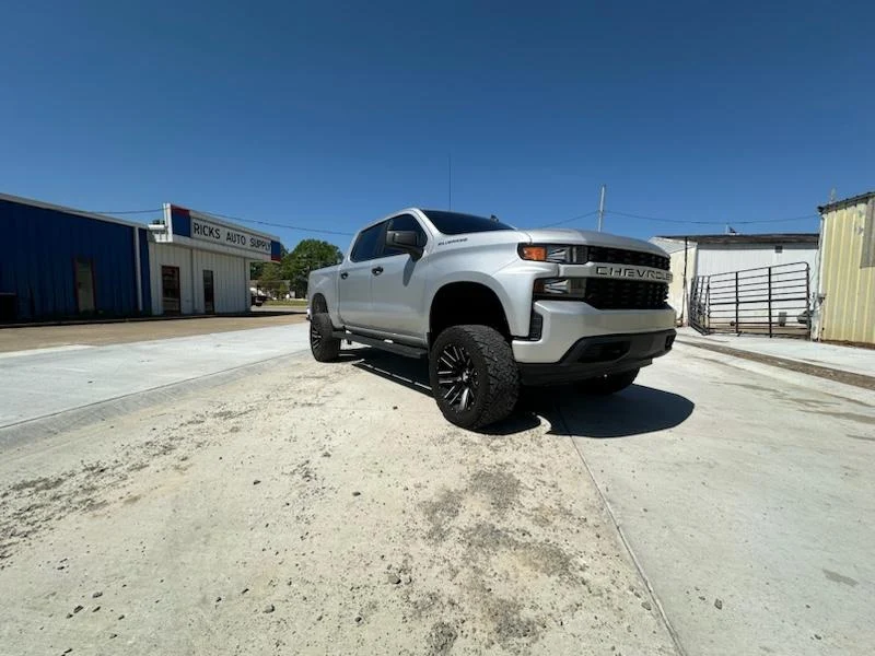 Silver Chevrolet Silverado with aftermarket wheels